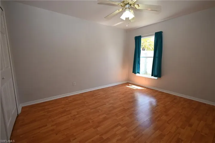 Empty room featuring a ceiling fan and wood finished floors