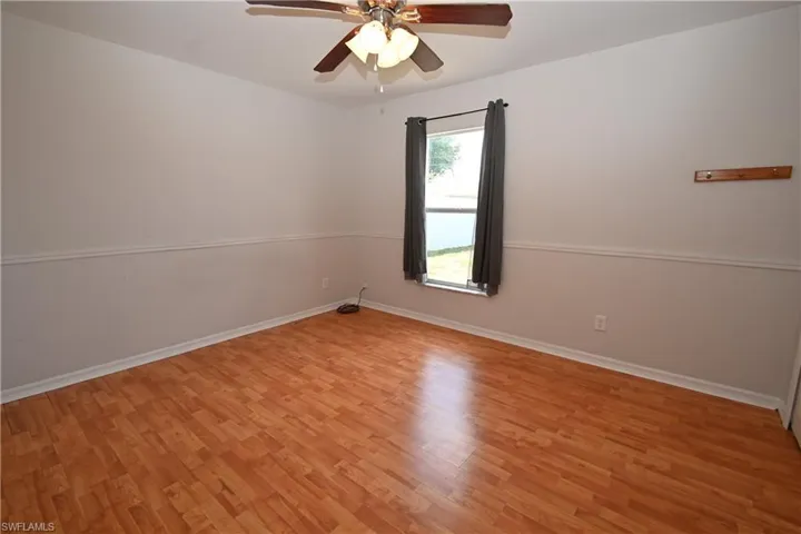 Unfurnished room featuring a ceiling fan and light wood-style flooring