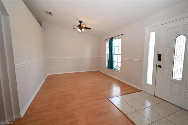 Foyer with light wood-type flooring and a ceiling fan