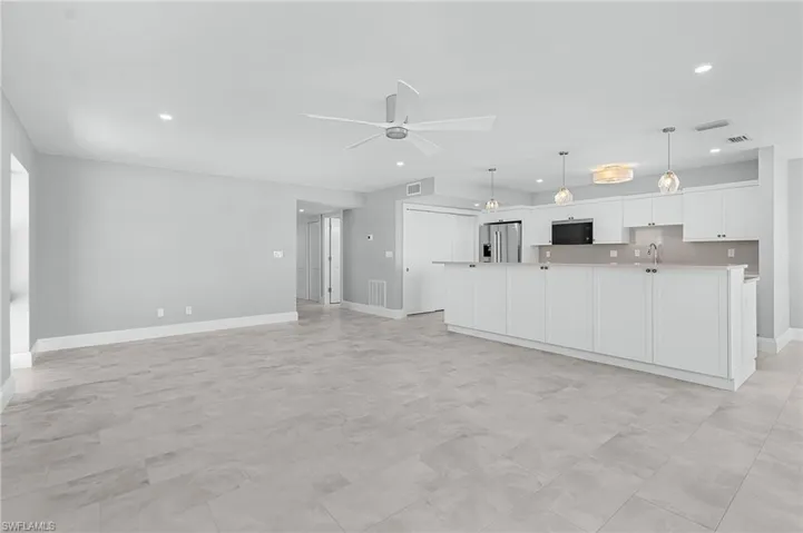 Unfurnished living room with recessed lighting and ceiling fan