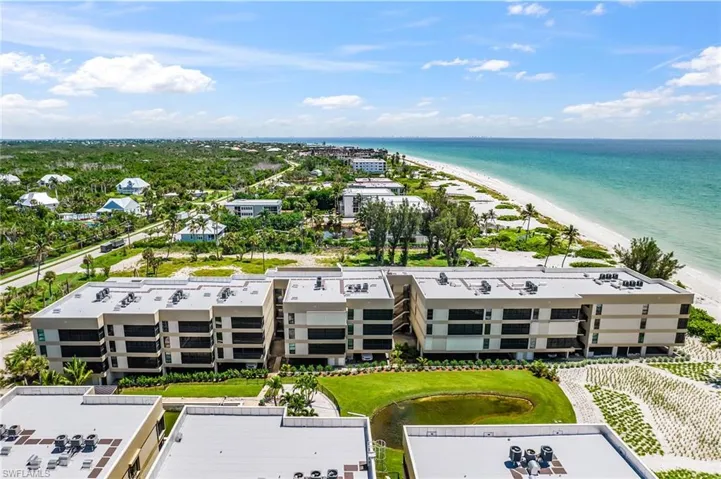Bird's eye view of apartment complex and unending shoreline