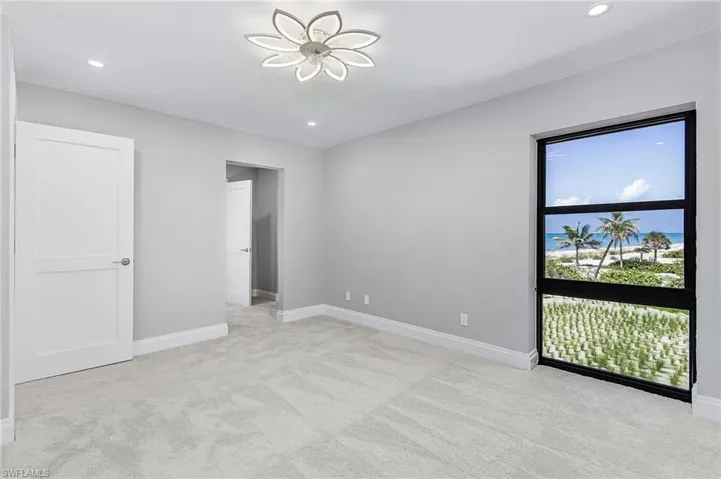 Unfurnished bedroom with light carpet and recessed lighting