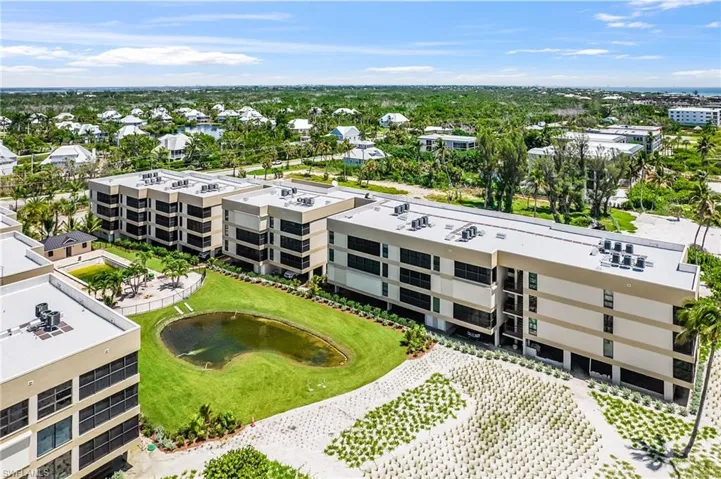 Drone / aerial view of apartment complex / building and a nearby body of water