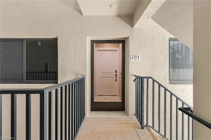 Property entrance with stucco siding
