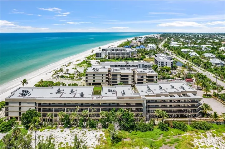 Bird's eye view of apartment complex / building and expansive coastline
