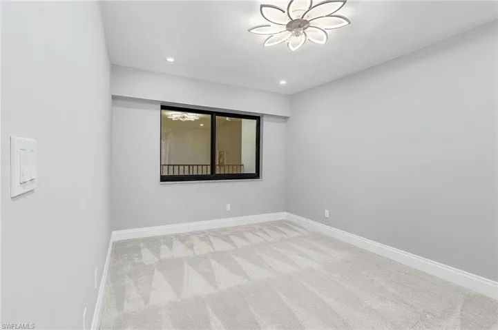 Spare room with light colored carpet and recessed lighting