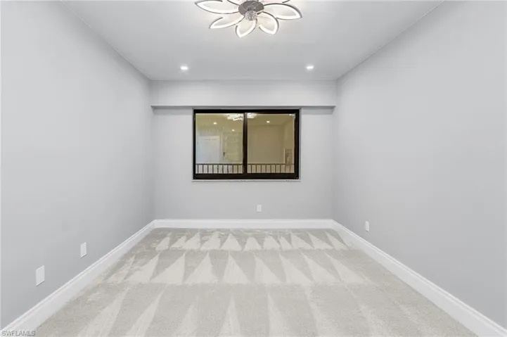 Spare room with light carpet and recessed lighting