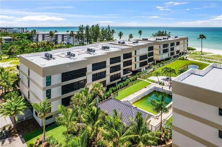 Aerial view of apartment complex and a large body of water