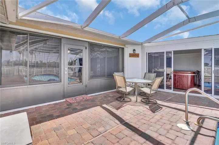 Sunroom featuring a hot tub