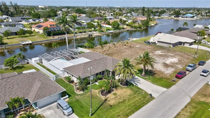 Birds eye view of property with a residential view and a water view