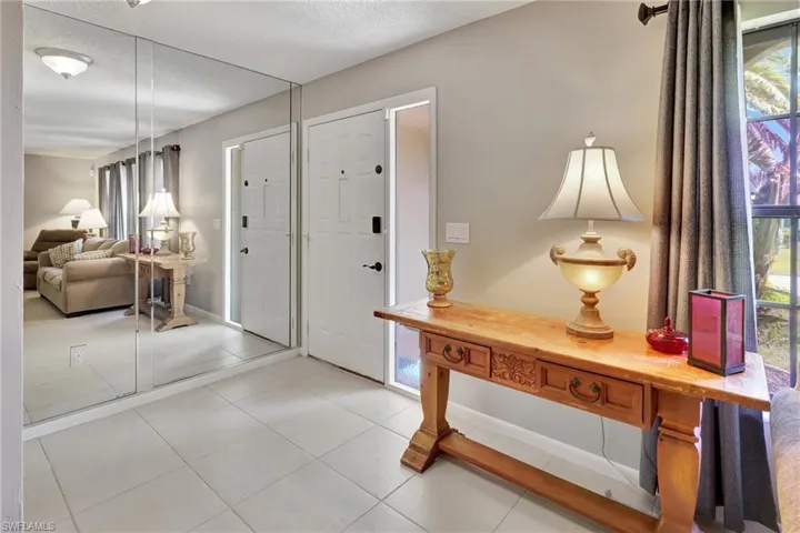 Foyer featuring a textured ceiling and light tile patterned floors
