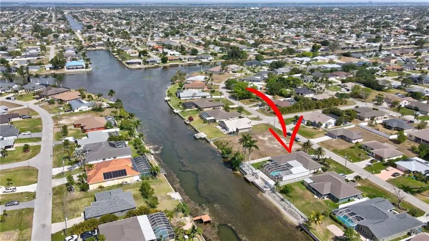 Birds eye view of property with a residential view and a water view