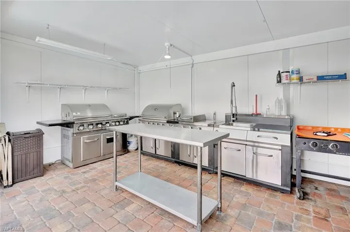 Kitchen with brick floor and a sink