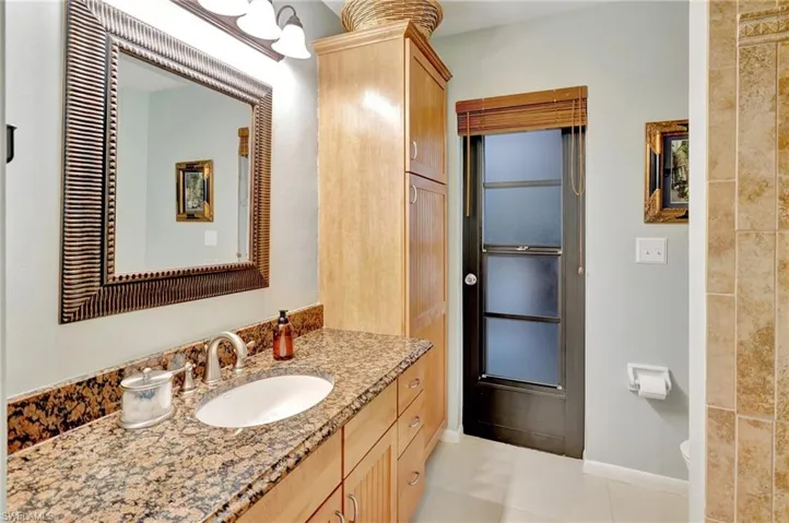 Bathroom with vanity and tile patterned flooring