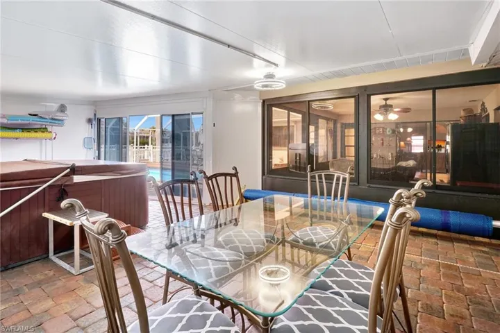 Dining room with a ceiling fan and a sunroom