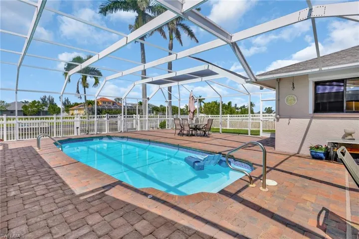 View of pool featuring a fenced in pool, a patio area, glass enclosure, and a fenced backyard