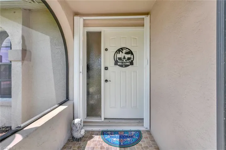View of exterior entry featuring stucco siding