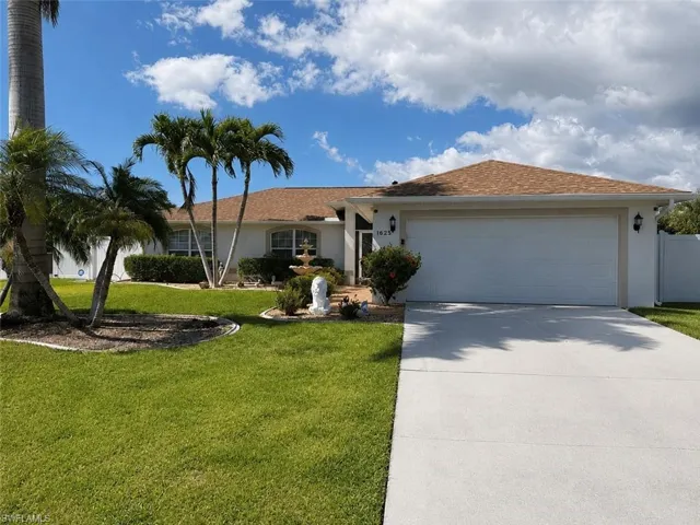 Single-story residence featuring a two-car garage, concrete driveway, and a shingle roof