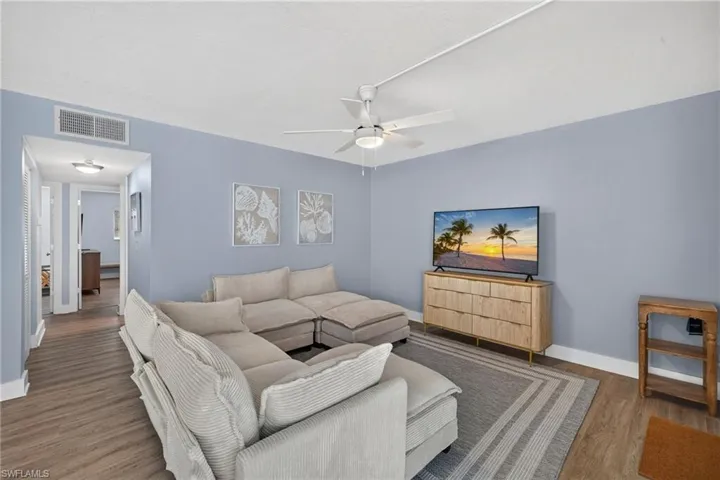 Wood-finish flooring throughout, complemented by light blue walls