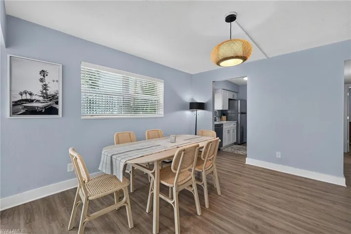 Wood-finish flooring with light blue walls and white trim