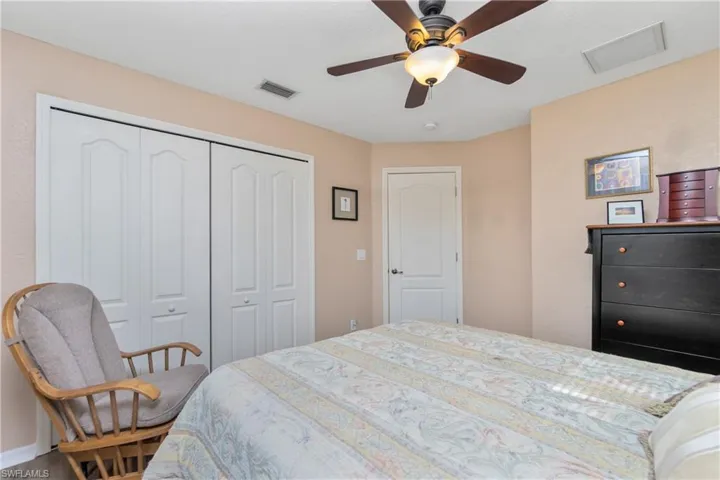 Bedroom featuring a closet, visible vents, and ceiling fan