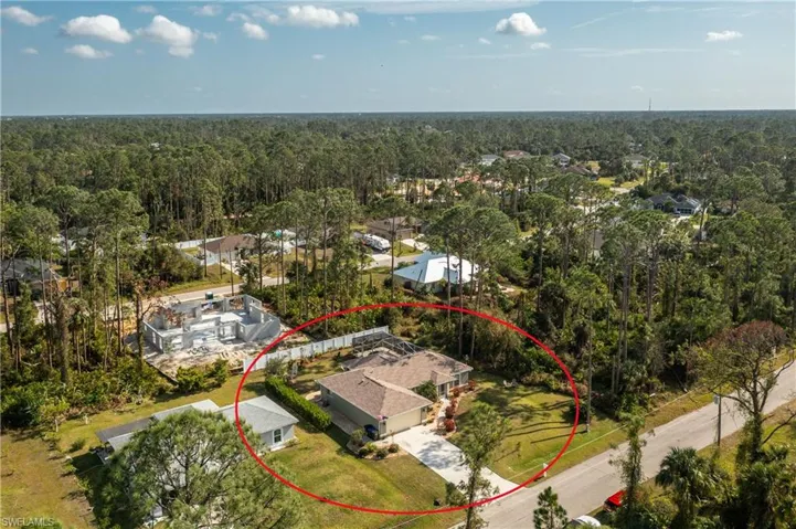 Aerial view featuring a wooded view