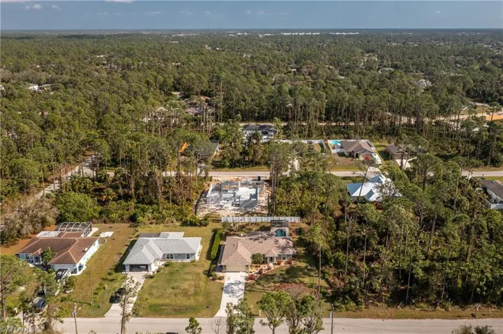 Bird's eye view featuring a forest view and a residential view