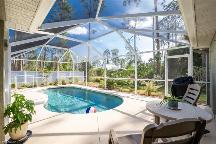 View of pool with a fenced in pool, a lanai, a patio area, and fence