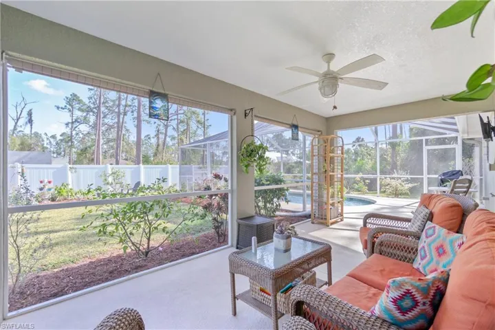 Sunroom / solarium featuring ceiling fan