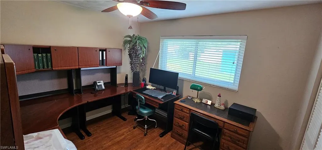 Living area with ceiling fan and wood finished floors