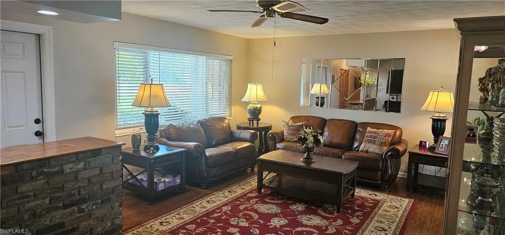 Living room with wood finished floors and a ceiling fan