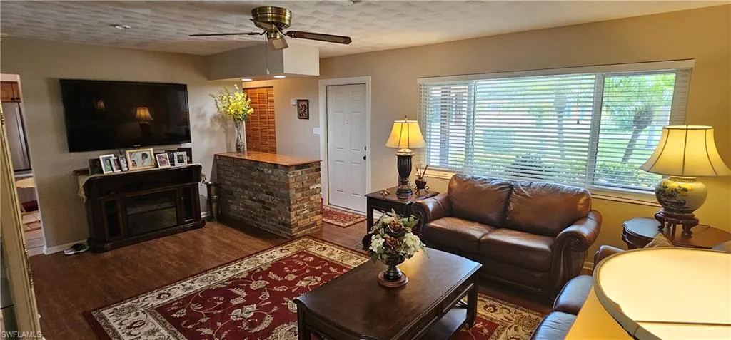 Office space featuring dark wood-style flooring and ceiling fan