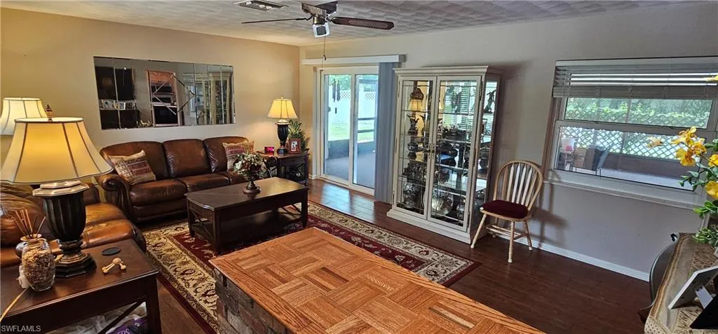 Bedroom featuring dark wood-type flooring, a closet, and ceiling fan