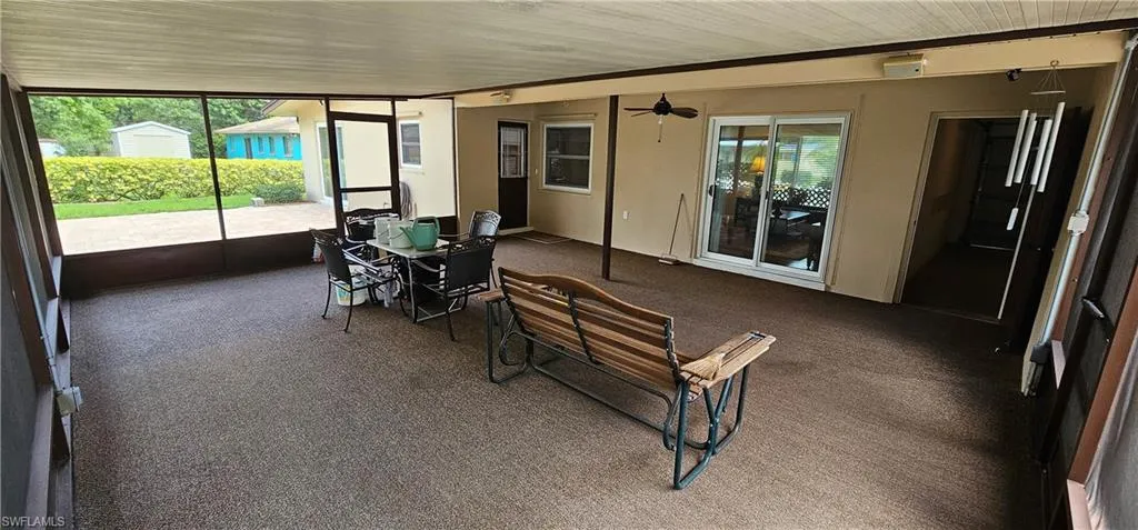 Living area with wood finished floors and a ceiling fan