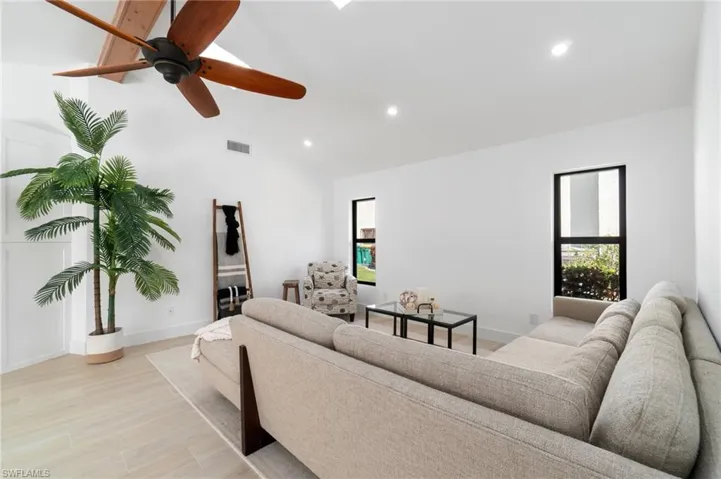 Living room featuring plenty of natural light, light wood-style flooring, and recessed lighting