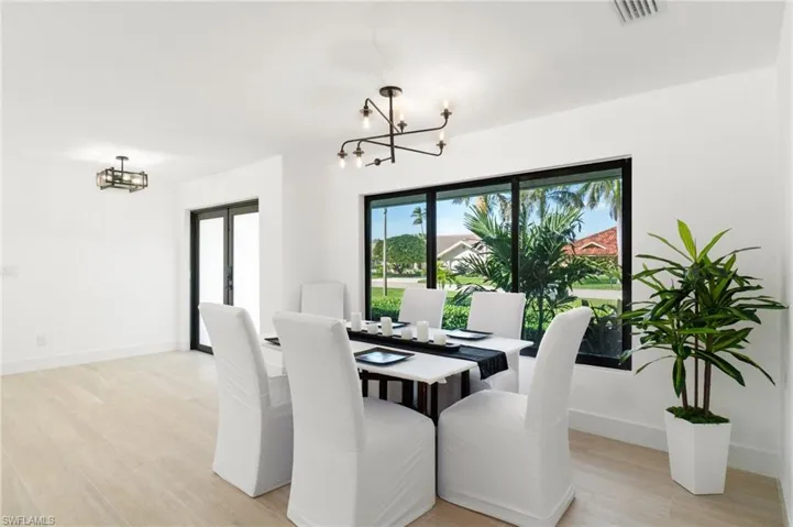 Dining space featuring a notable chandelier, and light wood finished floors