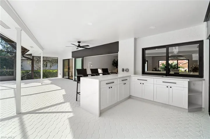 Outdoor Kitchen and bar area with hurricane impact sliders
