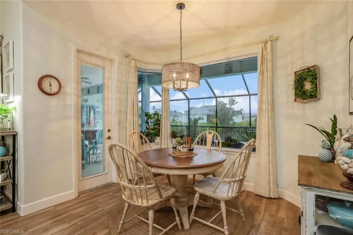 Breakfast nook Dining space featuring wood finished floors, healthy amount of natural light plus a chandelier.