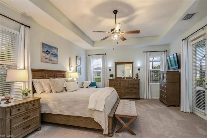 Owners Suite with a ceiling fan, Brand New carpet, Private entrance to pool and a tray ceiling