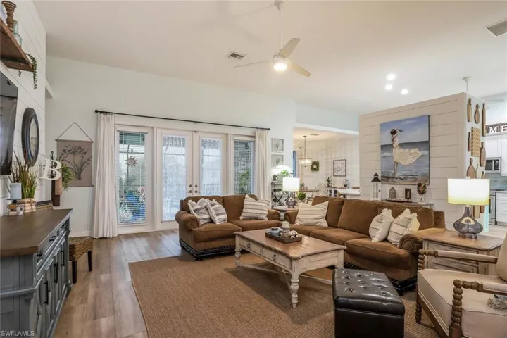 Living/Family room featuring wood finished floors, French doors to pool, and ceiling fan