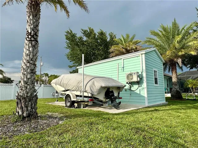 Bunk House featuring a white trim window and an exterior-mounted AC unit