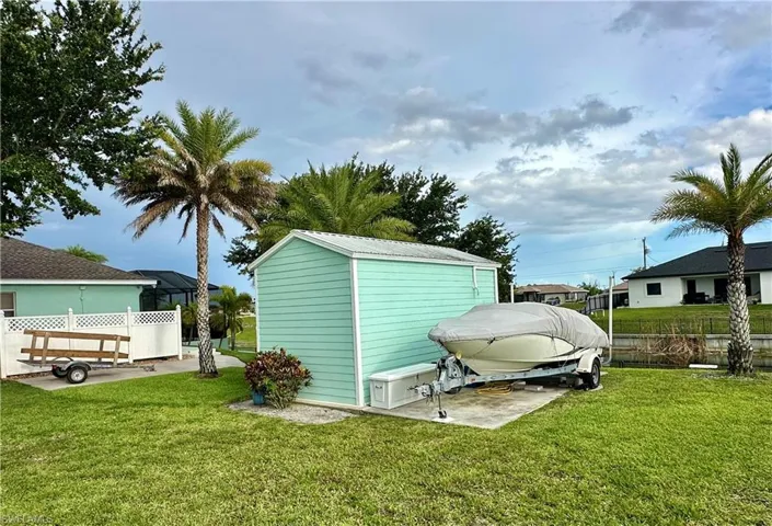 Bunk House with white trim, situated on a concrete pad
