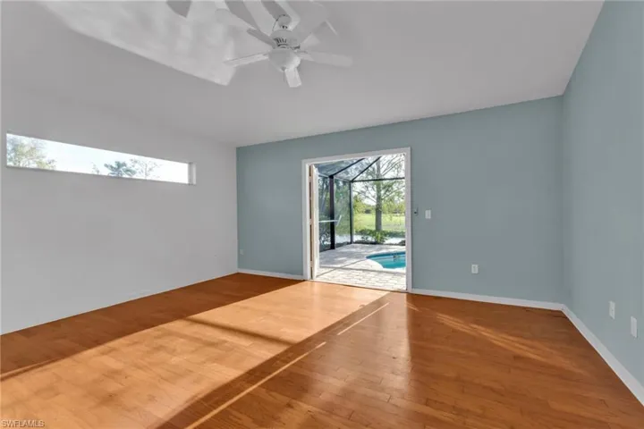 Unfurnished room featuring wood-type flooring, plenty of natural light, and ceiling fan