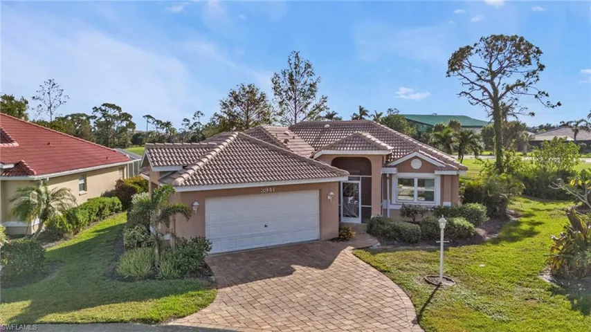 Mediterranean / spanish house with a front yard and a garage