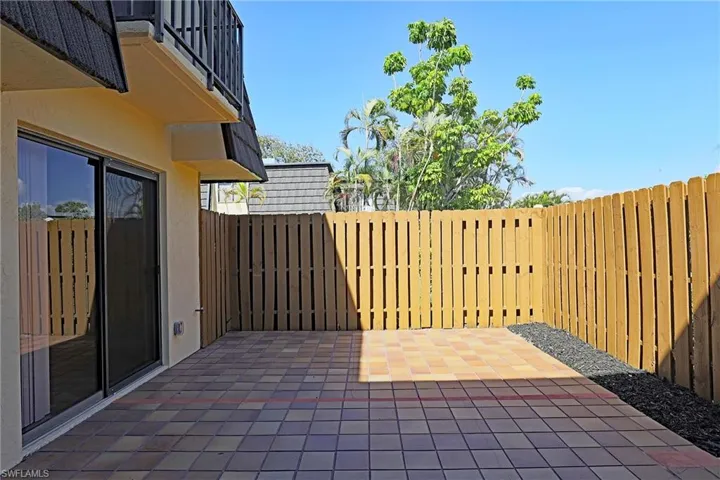 Fenced backyard with a patio