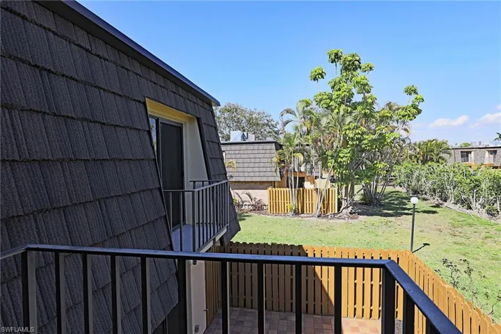 View of yard with a balcony