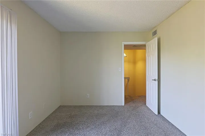 Unfurnished bedroom featuring carpet flooring and a textured ceiling