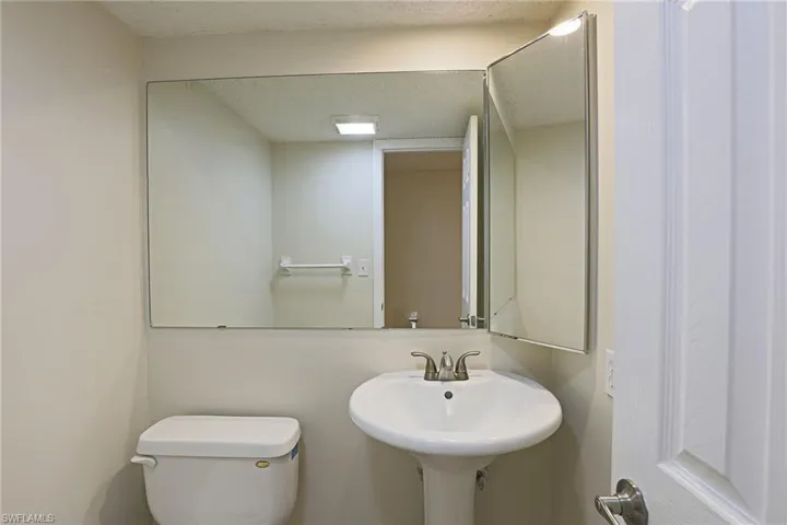 Bathroom featuring toilet and a textured ceiling