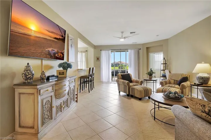 Living room featuring ceiling fan and light tile patterned floors