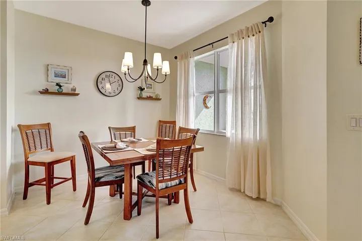 Dining space featuring an inviting chandelier and light tile patterned floors